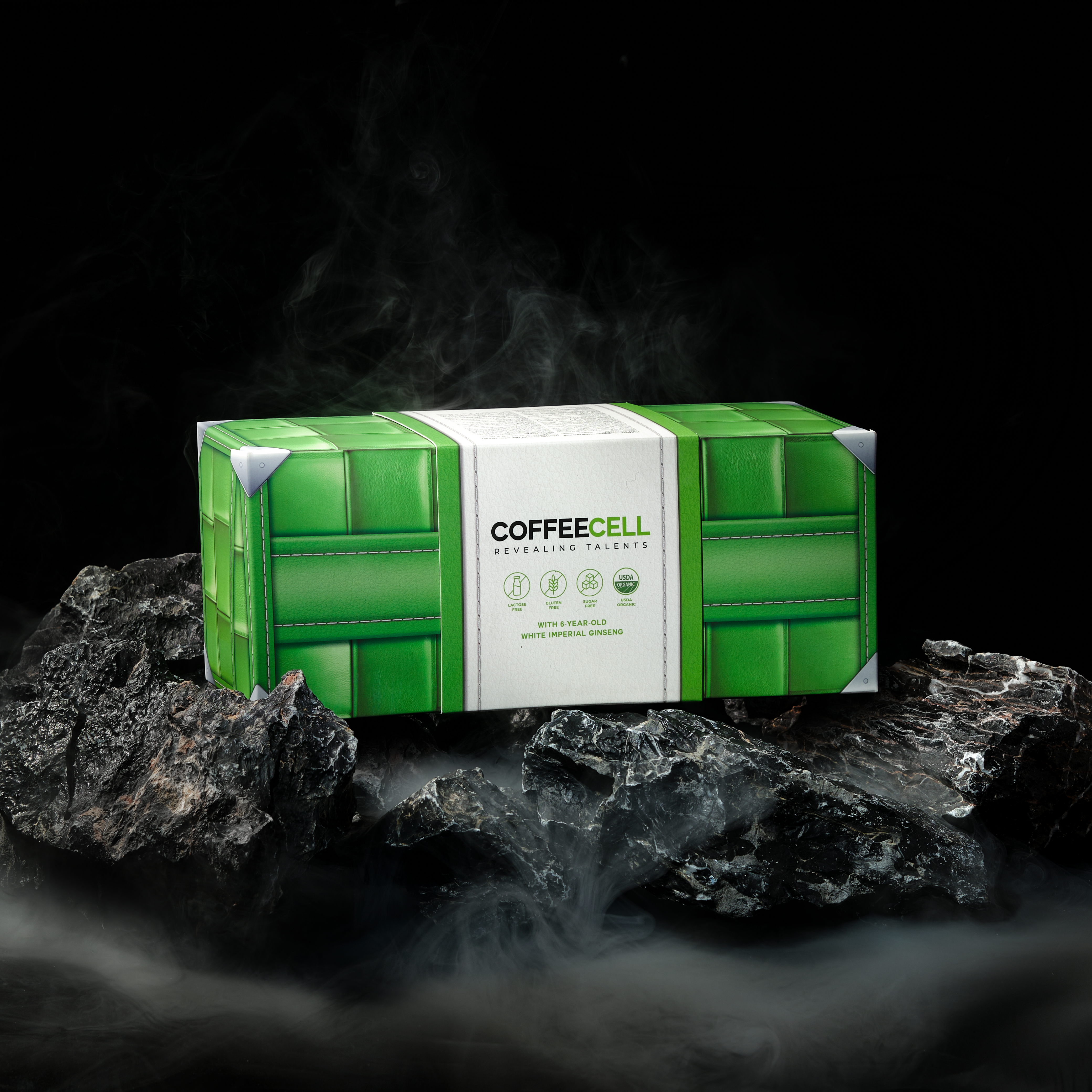 A green box of COFFEECELL green tea on rocks